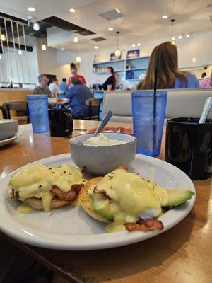 Eggs Benedict with bacon, avacado  , grits & coffee