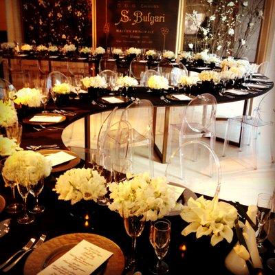 Bulgari Event by Michael Collins Decor with a snake table and white lush floral arrangements.