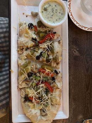 Vegetarian flat bread pizza with basil cream sauce.