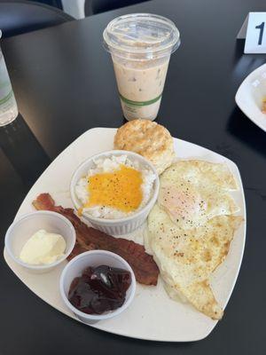 Breakfast plate with bacon and grits. Biscuit is homemade, grits super yummy. Iced latte one of the best I've had, smooth and rich