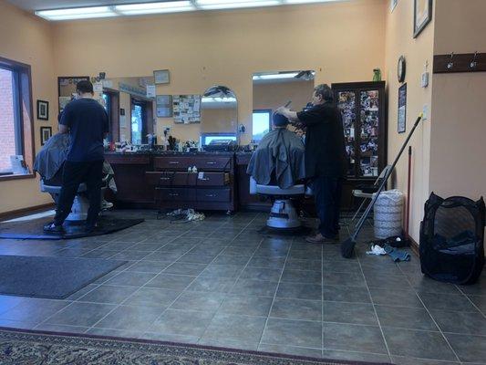 My son getting a haircut from barber Johnny Pinzone. His son is cutting hair on left. Great family. Great service.