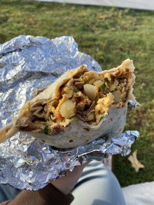 Machaca breakfast burrito. Has potatoes, grilled vegggies, beans, machaca and eggs.