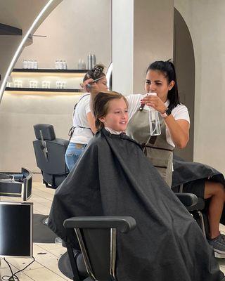 Look at that smile! Little one loves our haircut! Bring your kiddo in for a trim and watch them light up with joy.