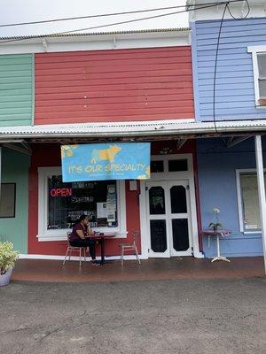 Outside, menu on the little table next to door