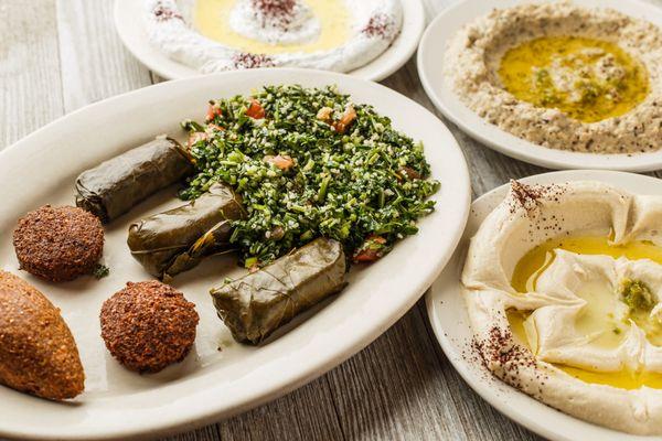 Aladdin's Special Appetizer for Two includes, hummus, baba ganuj, lebna, veggie grape leaves, tabouli, falafel and fried kibby.