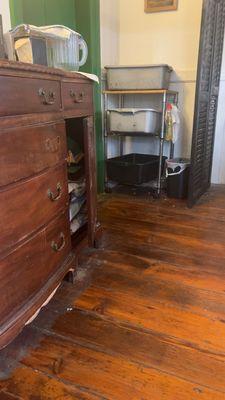 Dresser near our table; floors are clearly disgusting and unkept