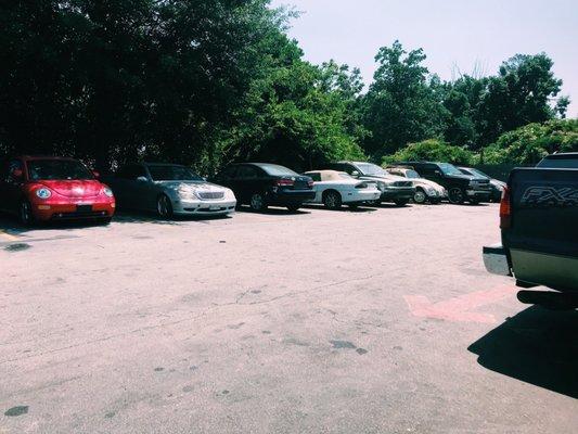 Cars waiting to be serviced and some for sale.