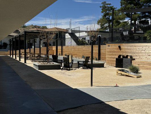 Standard backyard patio with Cornhole, bocci ball, swimming pool, fire pit