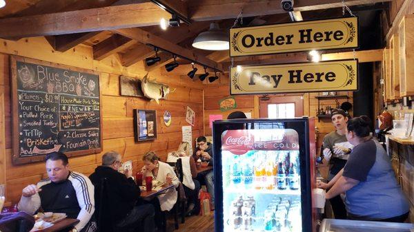 Rustic inside; menu board and order counter