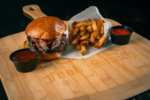 16 hour smoked pulled pork with BBQ sauce and pickles served on a housemade brioche bun with a side of fries.