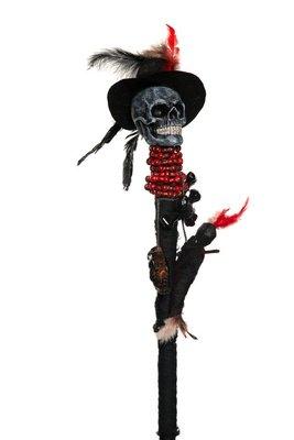 Staff w/ skull wearing a hat. Beads and feathers attached to staff