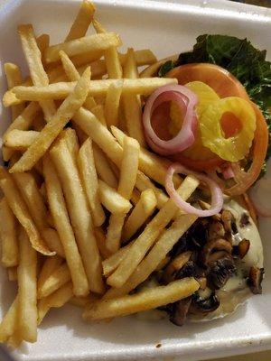 Mushroom swiss burger with fries.