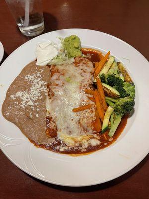 Enchiladas Rojas with beans and vegetables.