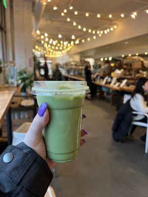 Matcha iced latte with oat milk and lavender added