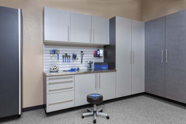 Silver Garage Cabinets with slatwall and a stainless steel countertop