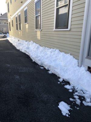 Snow left next to my house.  My driveway is already narrow.  This is after some had already melted!