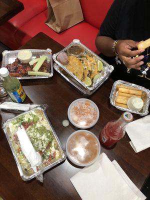 Carne Asada Chimichanga, wings sections in bbq sauce, Tostones, Yucca Fries, refried beans Mexican Side of Rice, and Jarritos