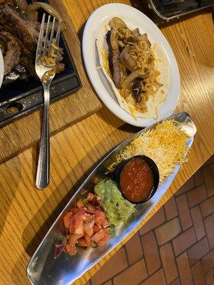 Flour tortilla and 'boat' of cheese, tomato, guacamole, and salsa