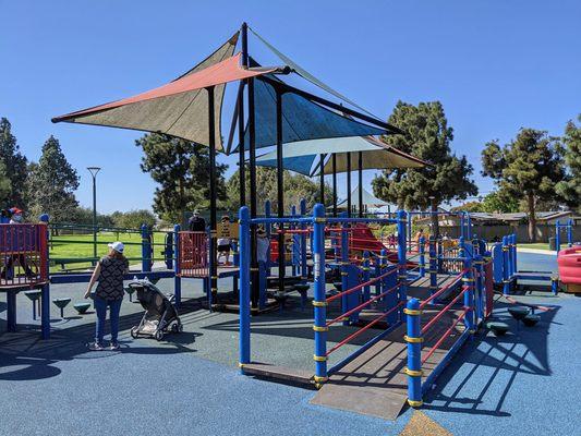 very large play area with sun canopies and padded rubber floors