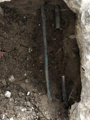 Before and after replacing a section of leaking pipe under ground inside a house