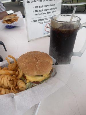 Double bacon cheeseburger with curly fries and a frosted mug of root beer.