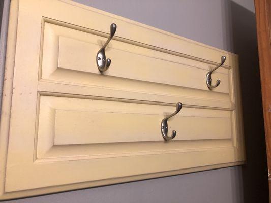 Old cabinet door turned bathroom hooks!!