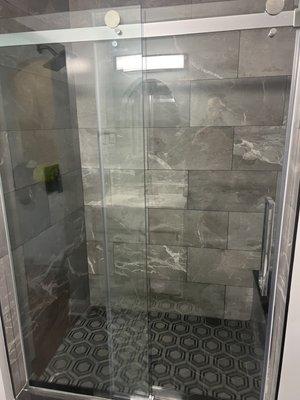 An amazing shower built from scratch , there was a wall there . This was originally a half bath