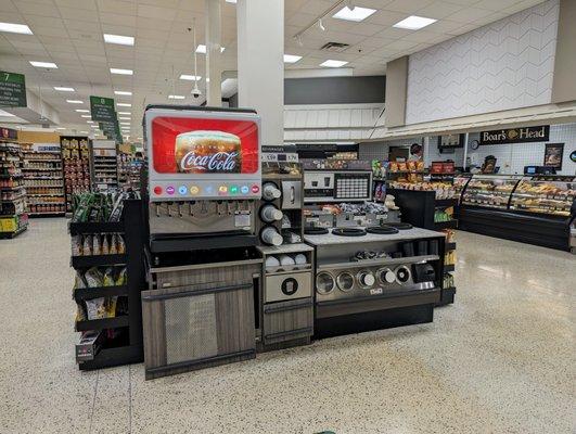 Inside in the back near the deli. This Publix has a self-serve Coke fountain drink machine.