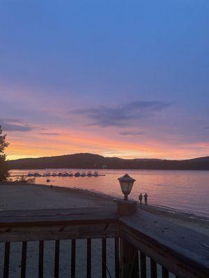 Outdoor patio view of lake at sunset