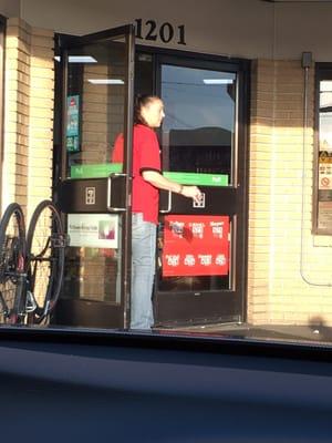 Yup!! She's been smoking while holding the door open as customers went in and out.