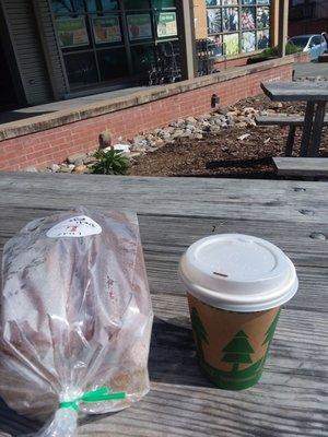 Rye bread and a coffee on a table out front.