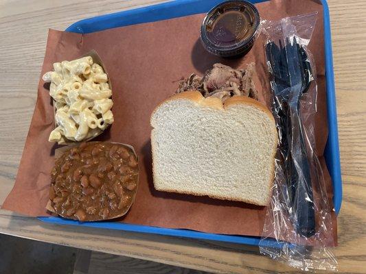 Pulled pork platter with a side of baked beans and Mac & cheese