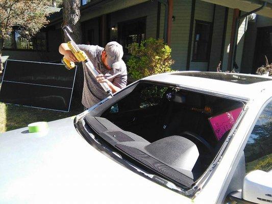 one of our skilled technicians installing a windshield -