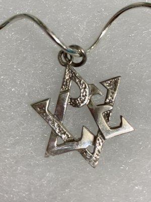 A Star of David pendent artistically merges with the word love