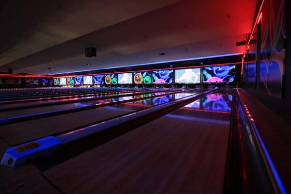 Planet Bowling lights with our 4 drop down projection screens over the lanes