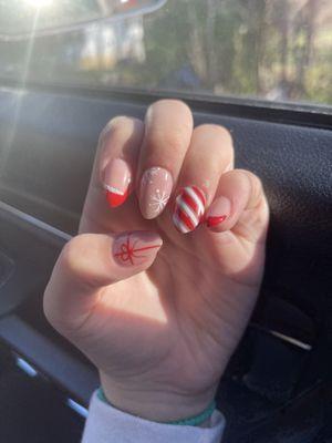 Her are my daughters nail  Pointer:Santa hat (with glitter) Middle:snow flakes  Ring: candy can stripes  Pinky:French tip Thumb: bow