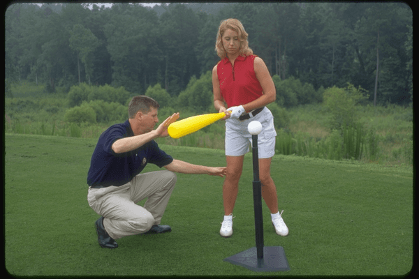 TOP 50 Golf Teacher Don Peterson helps student with swing.