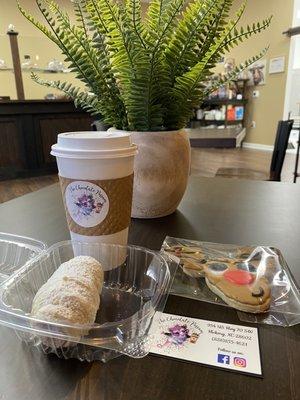 Coffee, chocolate possum tail (cream horn), frosted sugar cookie.