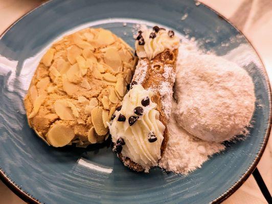 Almond cookie and powdered sugar cookie. Paired with a mini cannoli.