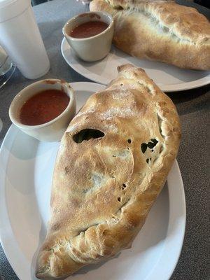 Calzone up close, stromboli in back