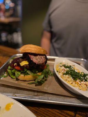 Bacon burger with brisket, and side of corn