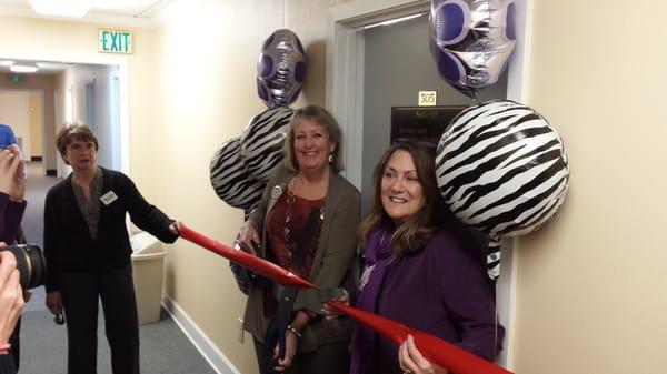 Sue Alford, Owner, and Jackie Barnett, General Manager, cut the ribbon with representatives of the Mobile Chamber of Commerce.