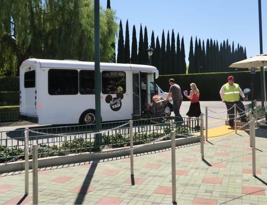 Mickey Van ADA Pick Up/Drop Off Area located at the South end of the Mickey and Friends Trams Loading area, by the structure.