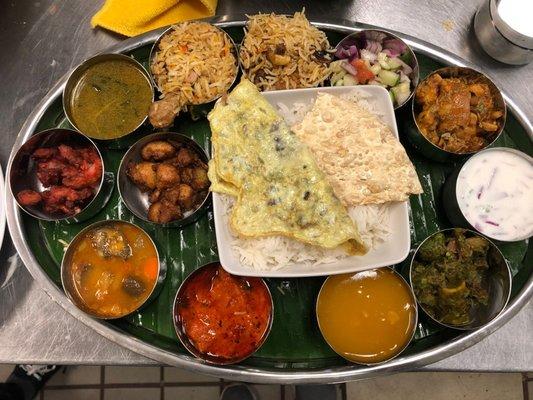 Non-veg Thali- Power plate of a min. 13 different non-veg items served with white rice and naan(flat bread)/omelet.