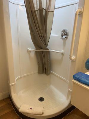 Circular shower with a square rain shower head.