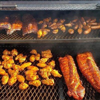 Smoker full of ribs, chicken and italian sausage.