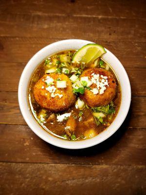 Carne asada taco soup with green chile rice balls, cotija cheese, cilantro & onion