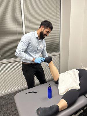 Dr. Karandeep working with a patient.