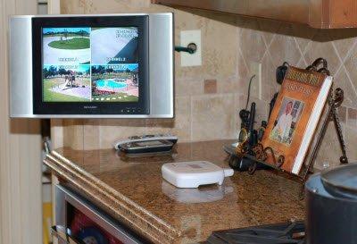 4-Camera Swann system showing 4 outdoor scenes simultaneously on kitchen TV. TV is wall mounted using a swivel bracket.