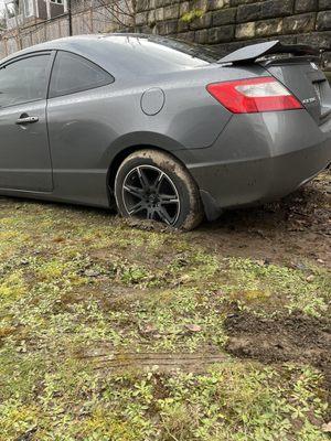 Driver's rear wheel also stuck in mud